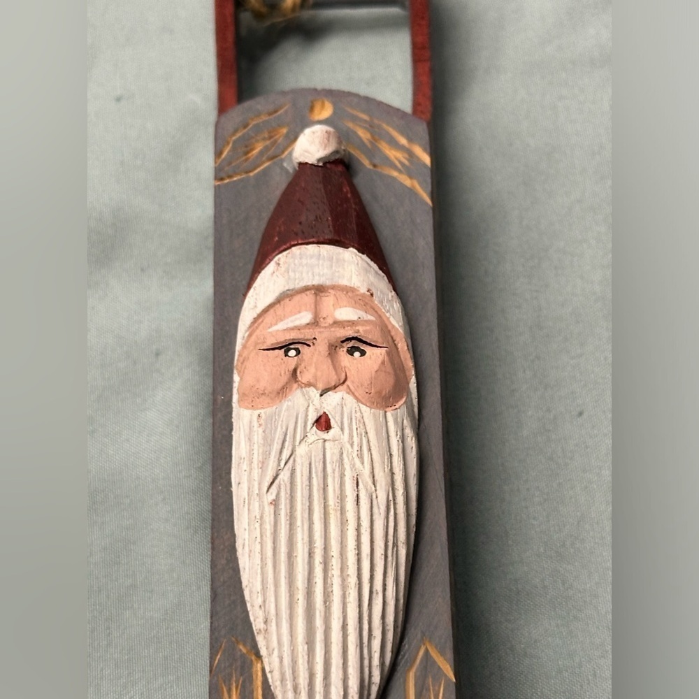 Cute Santa face in a wooden sled ornament.